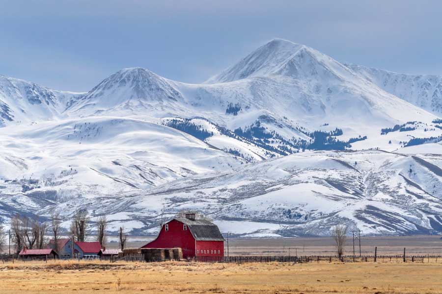 Photo of farm in front of mountains in Montana